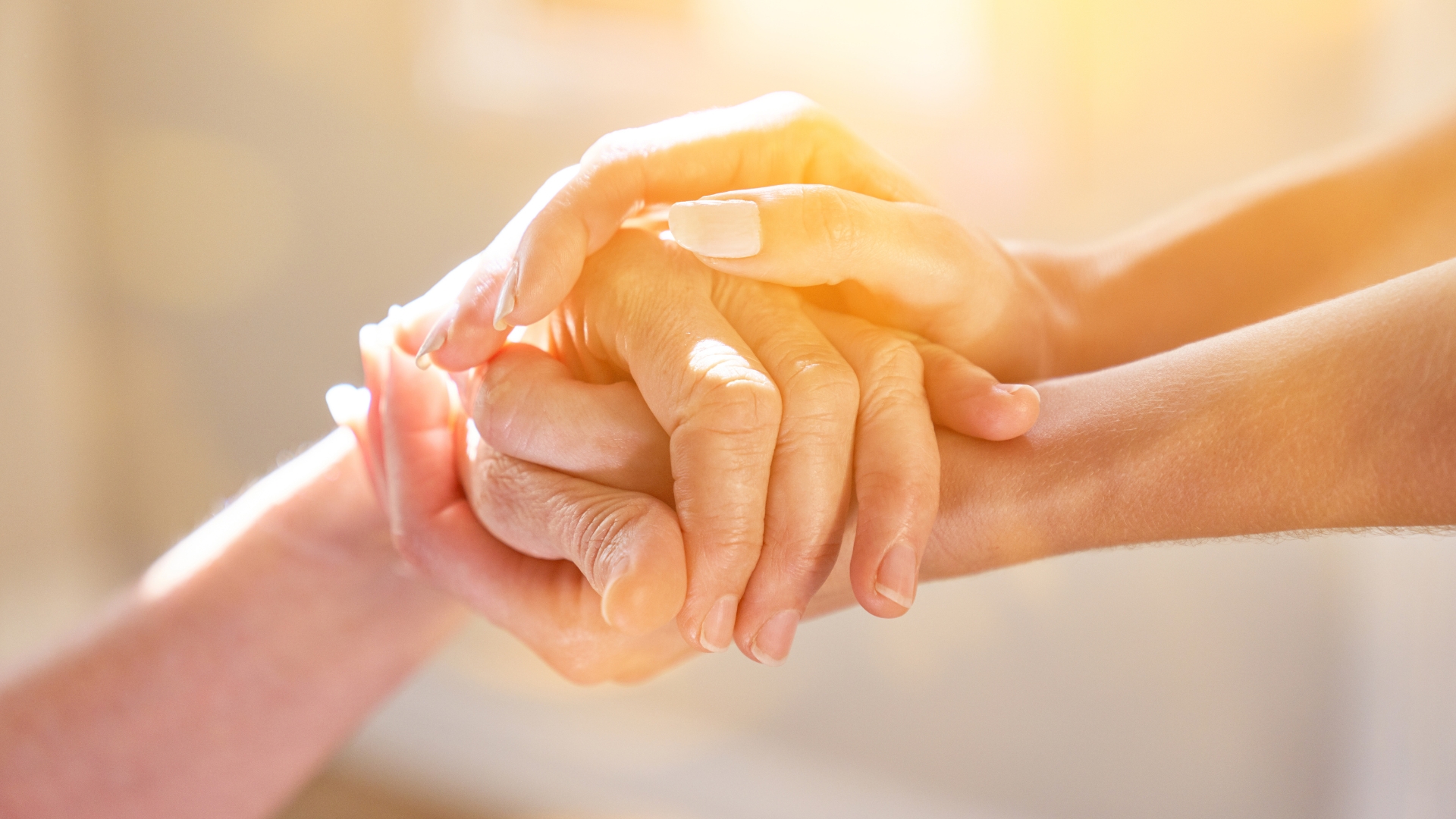 caregiver and elder hands